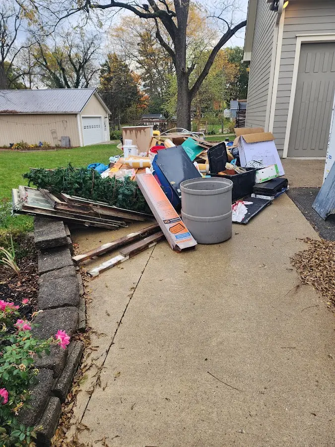 Dumpster being loaded with debris for Estate Cleanout Dumpster Rental in Point Pleasant Beach